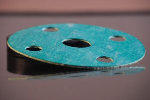 Close up of a green gasket made of asbestos